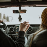 Happy couple enjoying their road trip thanks to the Hi-Way Towing safety driving tips.