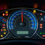 Dashboard displaying various gauges and warning lights, including speedometer, RPM gauge, and indicators for oil, battery, engine, and others.