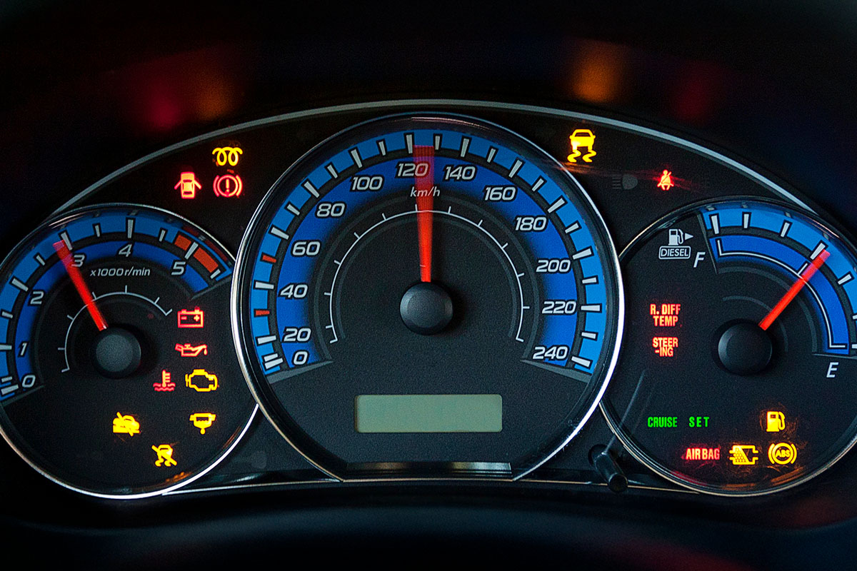 Dashboard displaying various gauges and warning lights, including speedometer, RPM gauge, and indicators for oil, battery, engine, and others.